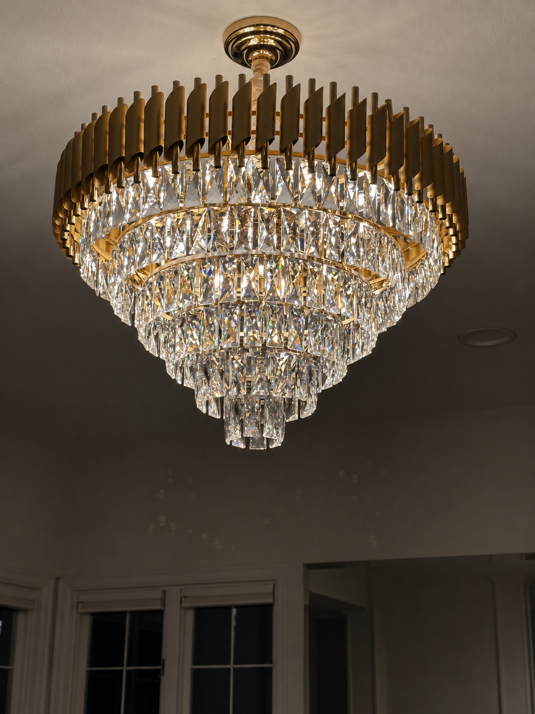 Brass and crystal chandelier installation in a NOVA Build renovation