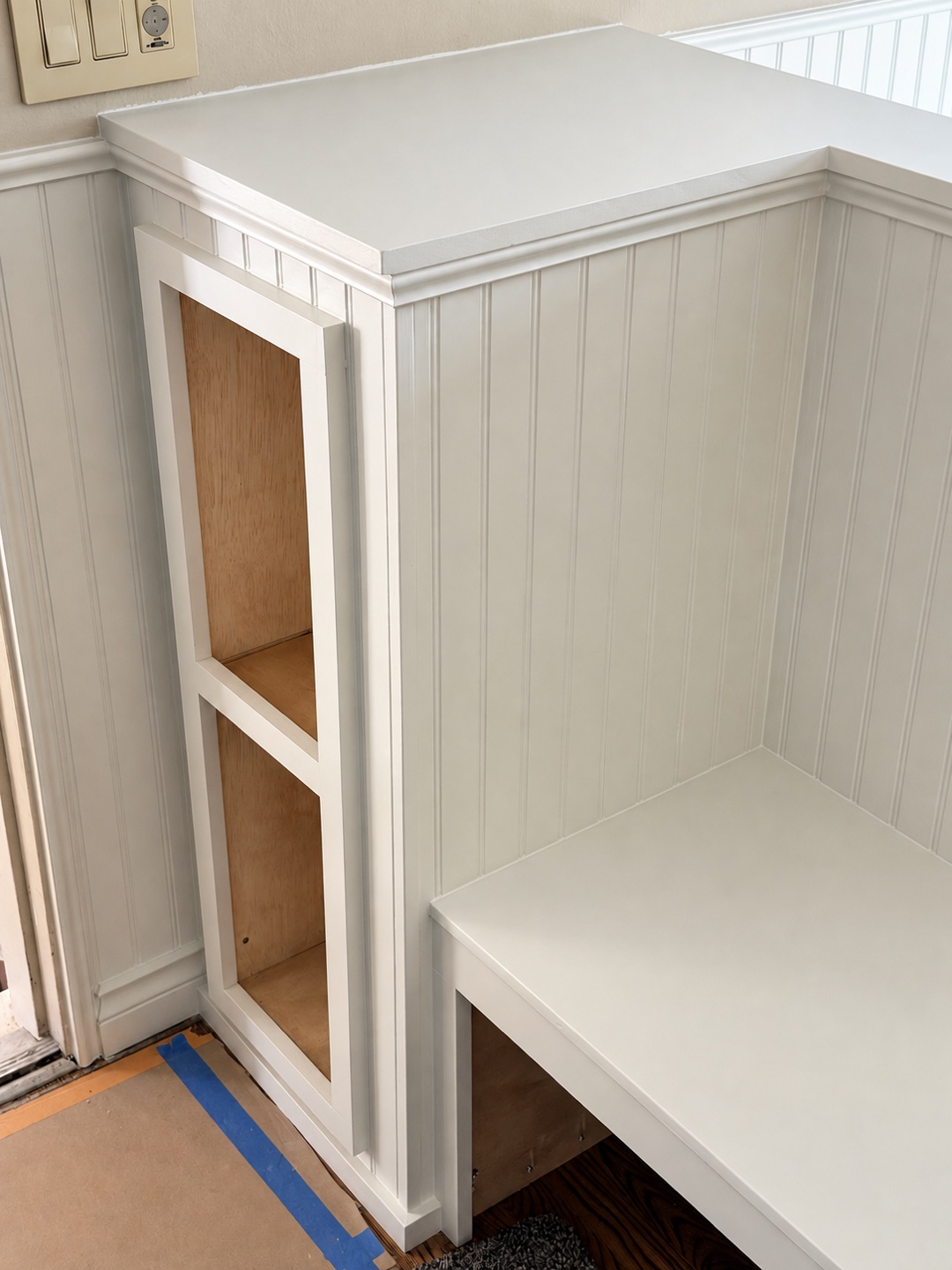 Trim and beadboard detail on the built-in entry bench.