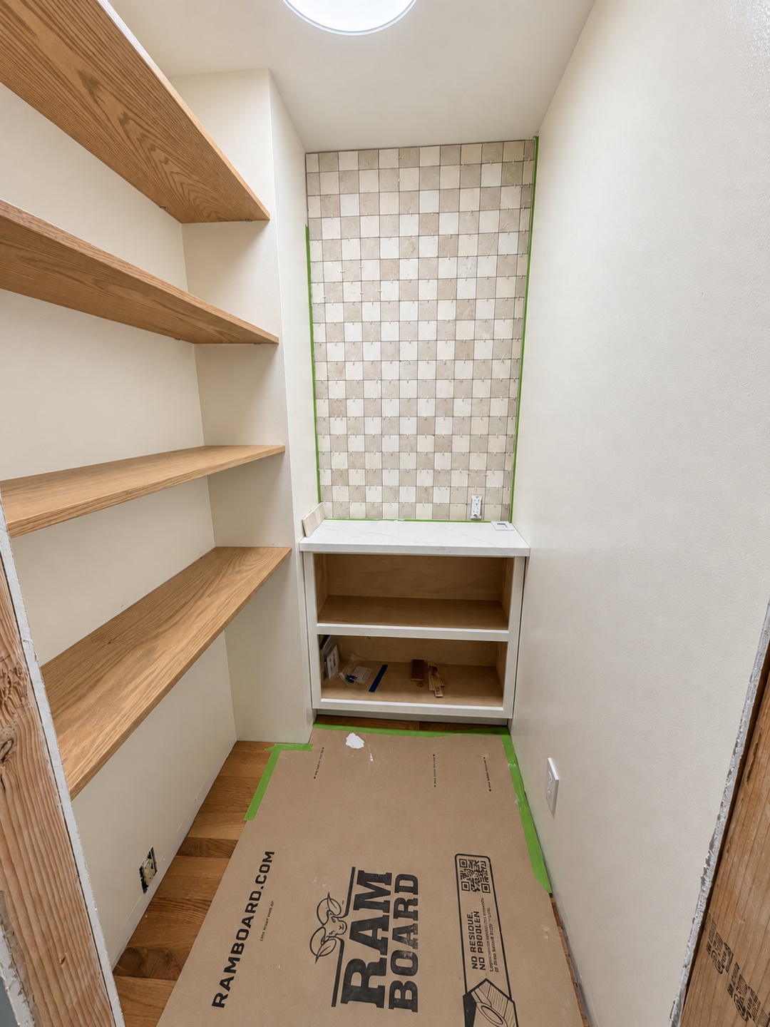 Wood pantry shelves and cabinetry during installation.